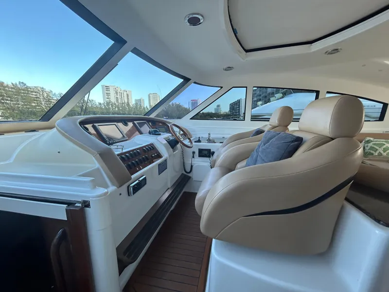 Slide: The Image of Interior of 2006 Neptunus 55 Cabrio yacht with luxurious seating and modern dashboard. - 10