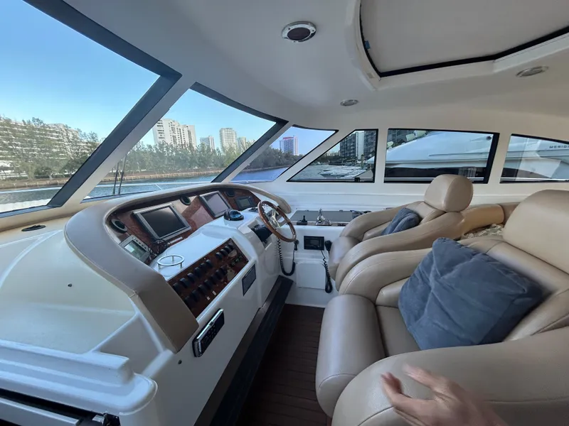 Slide: The Image of 2006 Neptunus 55 Cabrio yacht interior with leather seating and modern dashboard. - 11