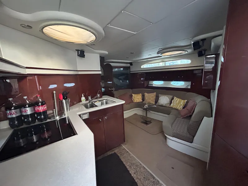 Slide: The Image of Luxurious interior of 2006 Neptunus 55 Cabrio yacht with modern kitchen and cozy seating area. - 15
