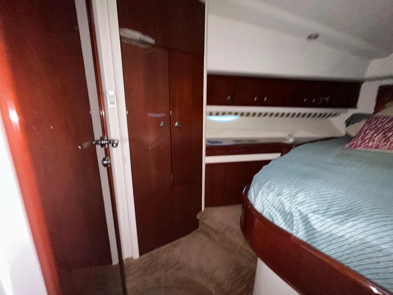 Slide: The Image of Interior cabin of 2006 Neptunus 55 Cabrio yacht with wood paneling and bed. - 19