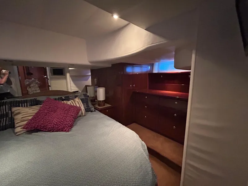 Slide: The Image of Luxurious bedroom interior of 2006 Neptunus 55 Cabrio yacht with cozy bedding and elegant wood cabinetry. - 24