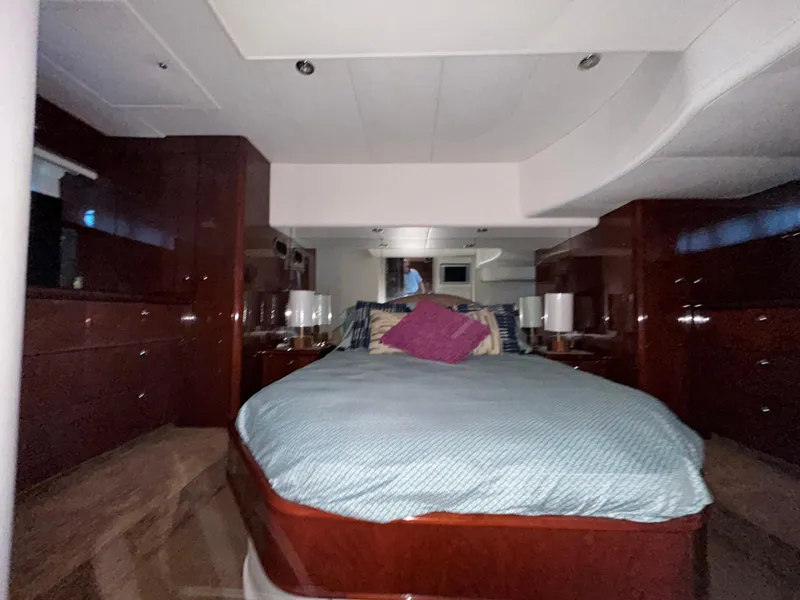 Slide: The Image of Luxurious bedroom interior of 2006 Neptunus 55 Cabrio yacht with elegant wood finish. - 25