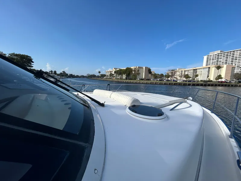 Slide: The Image of 2006 Neptunus 55 Cabrio yacht cruising on a sunny day near waterfront buildings. - 32
