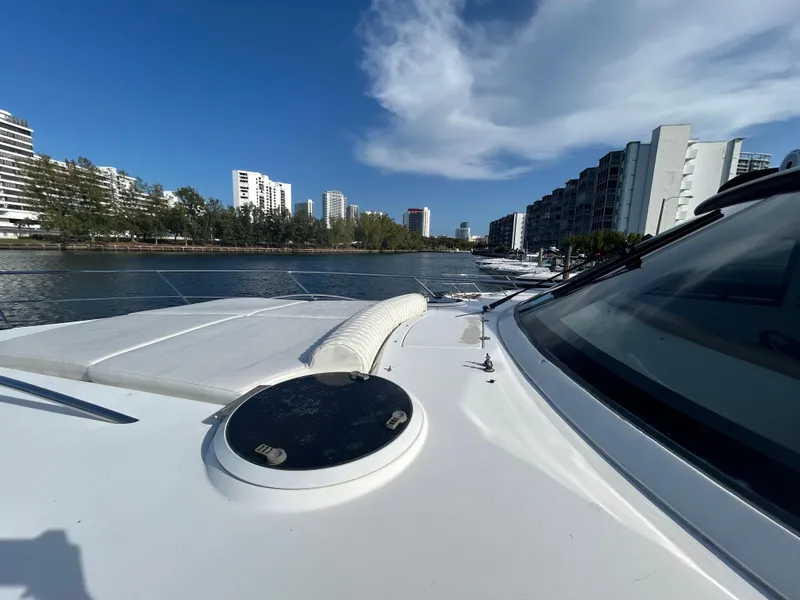 Slide: The Image of 2006 Neptunus 55 Cabrio yacht docked near modern waterfront buildings. - 33