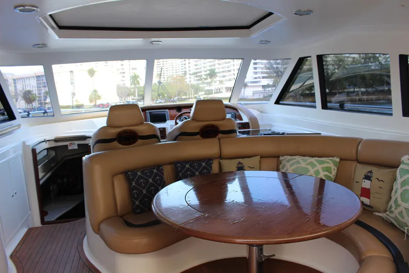 Slide: The Image of Interior of 2006 Neptunus 55 Cabrio yacht with leather seating and wooden table. - 8