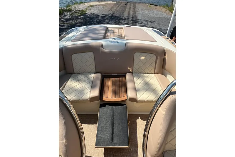 Slide: The Image of 2018 Chris-Craft Launch 23 boat interior with beige seating and wooden accents. - 12