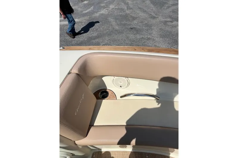 Slide: The Image of 2018 Chris-Craft Launch 23 boat interior with beige seating and cup holder. - 15