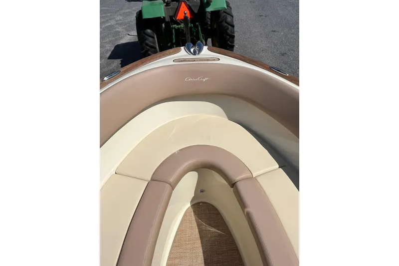 Slide: The Image of 2018 Chris-Craft Launch 23 boat interior with beige seating and wood accents. - 16