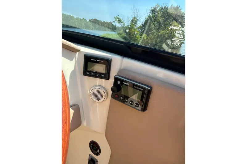 Slide: The Image of 2018 Chris-Craft Launch 23 dashboard with Volvo Penta and Fusion controls. - 17