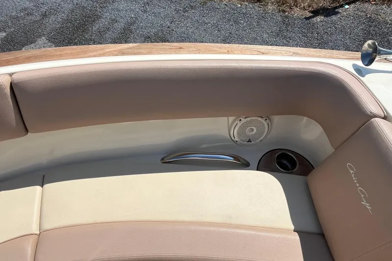 Slide: The Image of 2018 Chris-Craft Launch 23 boat interior with beige seating and speaker detail. - 21