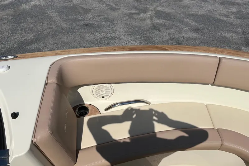 Slide: The Image of 2018 Chris-Craft Launch 23 boat interior with beige seating and cup holder. - 23