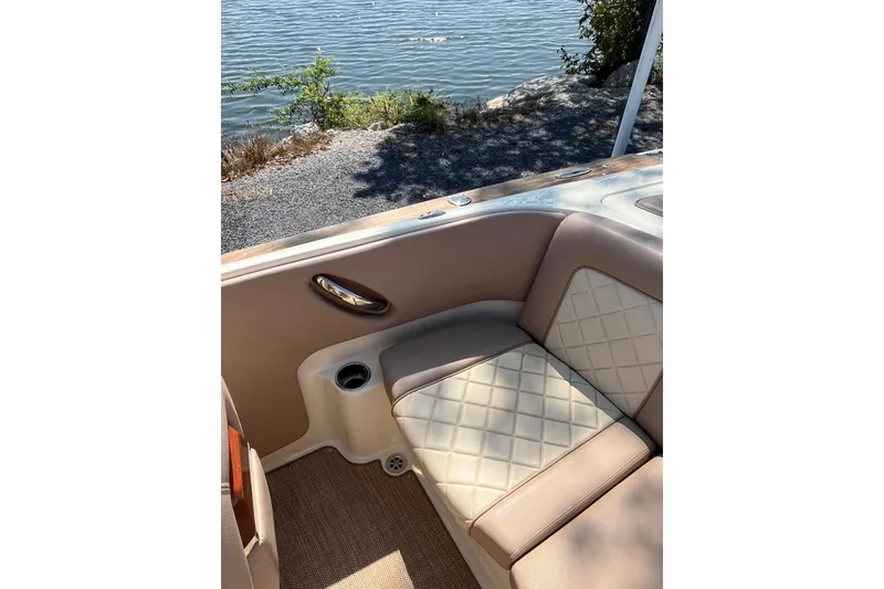 Slide: The Image of Luxurious interior of 2018 Chris-Craft Launch 23 boat by the water. - 7