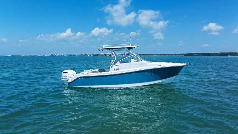 Slide: The Image of 2018 Edgewater 280CX Crossover boat on open sea. - 11