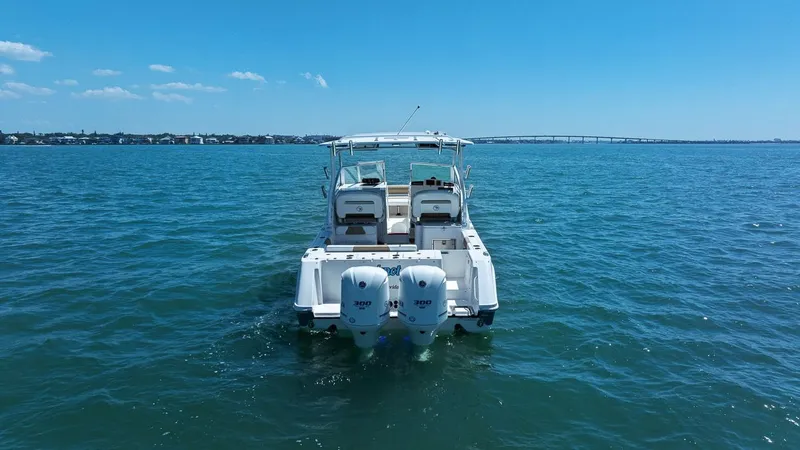 Slide: The Image of 2018 Edgewater 280CX Crossover on open water with bridge in background. - 13
