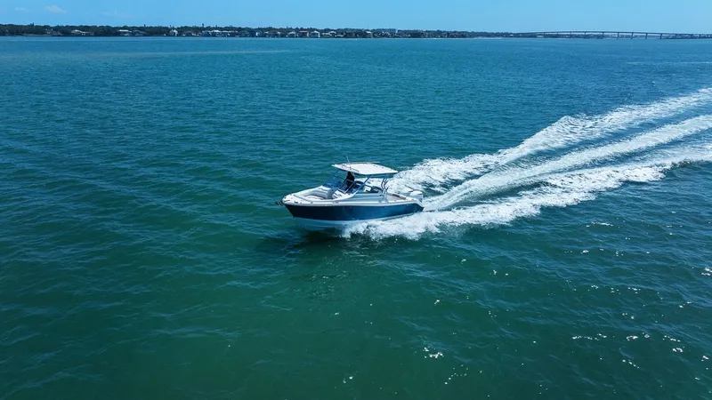 Slide: The Image of 2018 Edgewater 280CX Crossover cruising on open sea at full speed. - 15