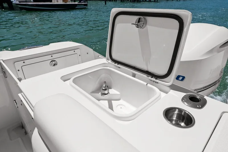 Slide: The Image of Edgewater 280CX Crossover 2018 with open storage compartment on water. - 19