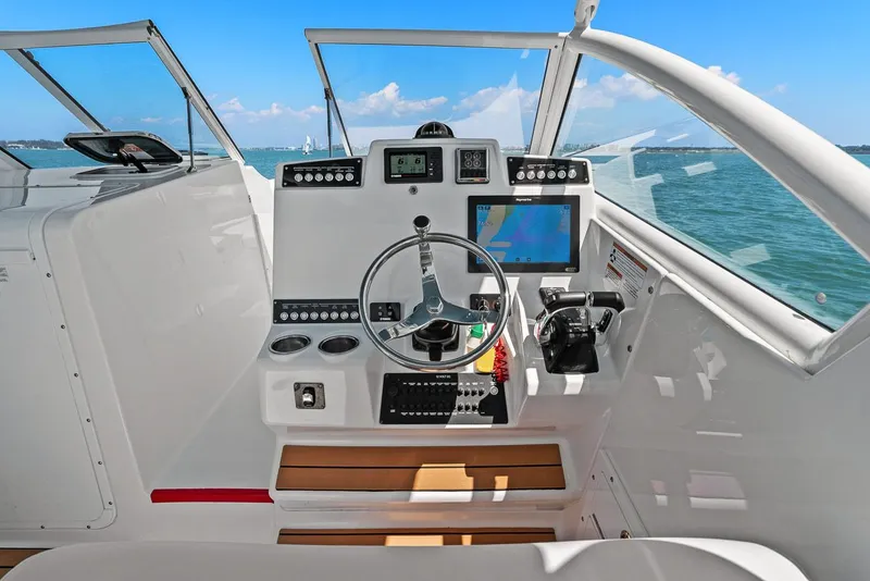 Slide: The Image of 2018 Edgewater 280CX Crossover cockpit with steering and navigation system. - 3