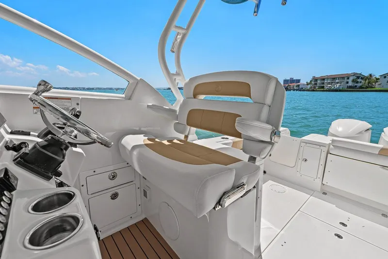 Slide: The Image of Interior of a 2018 Edgewater 280CX Crossover boat overlooking the water. - 30