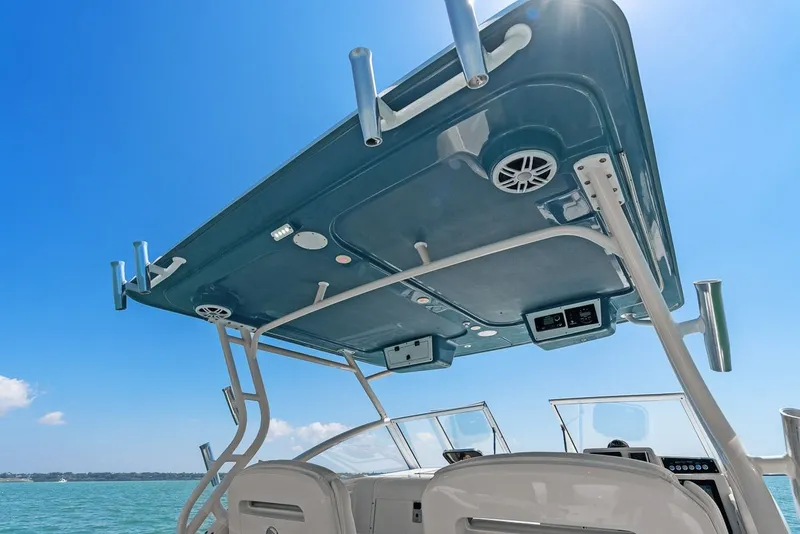 Slide: The Image of Edgewater 280CX Crossover 2018 boat canopy and helm in sunny weather. - 41