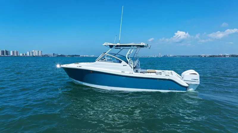 Slide: The Image of 2018 Edgewater 280CX Crossover boat on open water. - 9