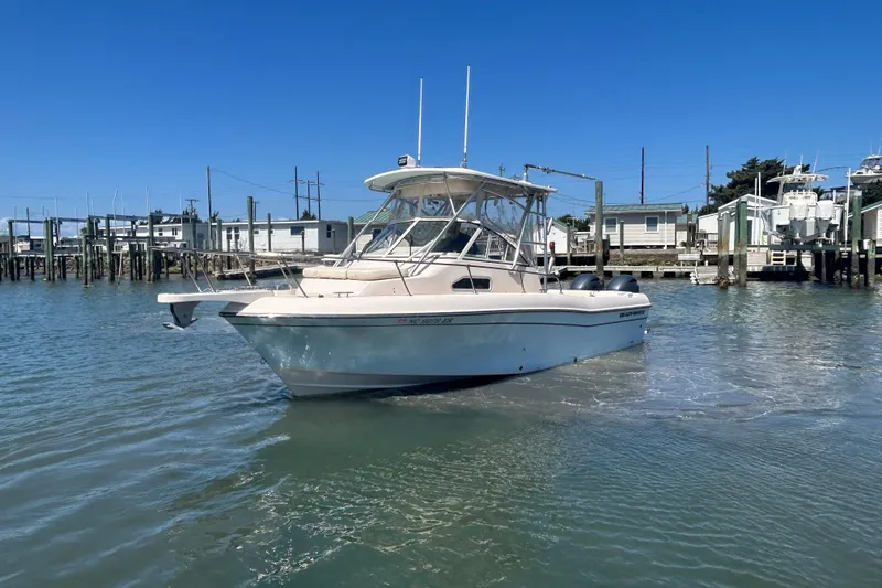 Slide: The Image of 2021 Grady-White Gulfstream 232 boat docked in a marina under clear blue skies. - 11