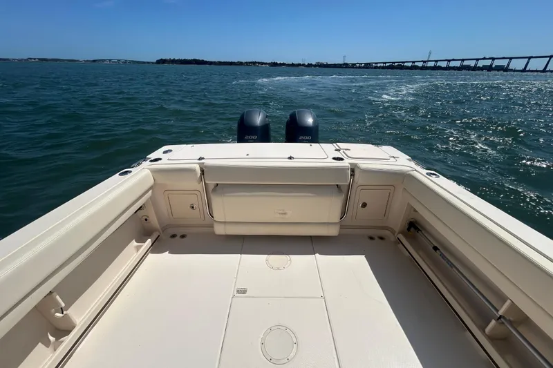 Slide: The Image of 2021 Grady-White Gulfstream 232 boat deck with twin engines on open water. - 14