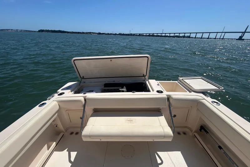 Slide: The Image of Grady-White Gulfstream 232 boat interior with open storage, on calm water near a bridge. - 15