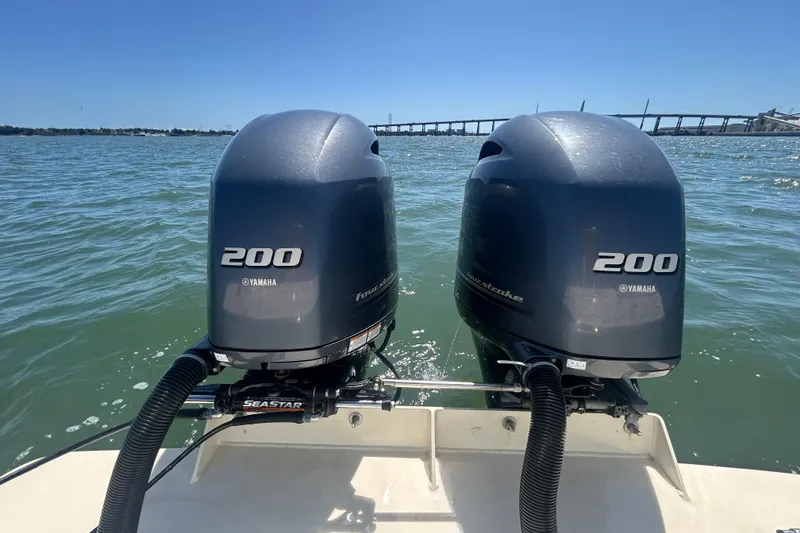 Slide: The Image of Twin Yamaha 200 engines on a 2021 Grady-White Gulfstream 232 boat in open water. - 16