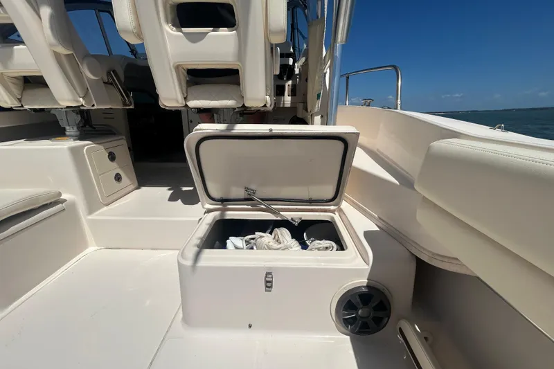 Slide: The Image of 2021 Grady-White Gulfstream 232 boat interior with open storage compartment and seating. - 25