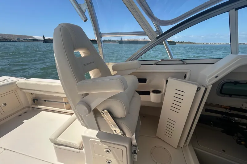 Slide: The Image of 2021 Grady-White Gulfstream 232 boat interior with helm seat and ocean view. - 27