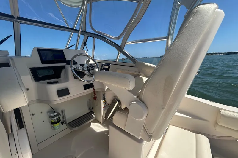 Slide: The Image of Interior of 2021 Grady-White Gulfstream 232 boat with steering wheel and controls. - 29