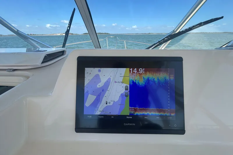 Slide: The Image of Grady-White Gulfstream 232 boat with Garmin navigation display, showing depth and map data. - 31
