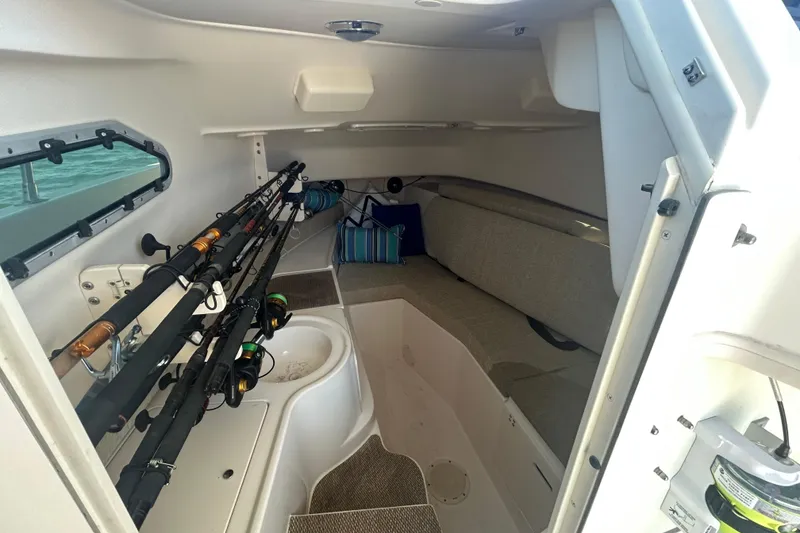 Slide: The Image of 2021 Grady-White Gulfstream 232 cabin interior with fishing rods and seating area. - 41