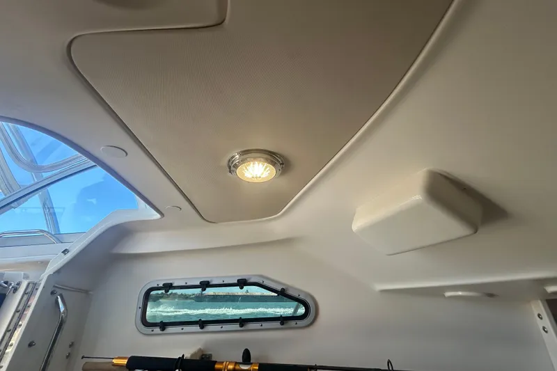 Slide: The Image of Interior view of 2021 Grady-White Gulfstream 232 boat cabin ceiling with light fixture. - 43