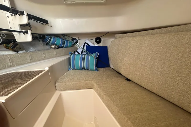 Slide: The Image of Interior of 2021 Grady-White Gulfstream 232 boat with cushioned seating and fishing rods. - 44