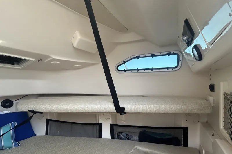 Slide: The Image of 2021 Grady-White Gulfstream 232 cabin interior with cushioned seating and window. - 45