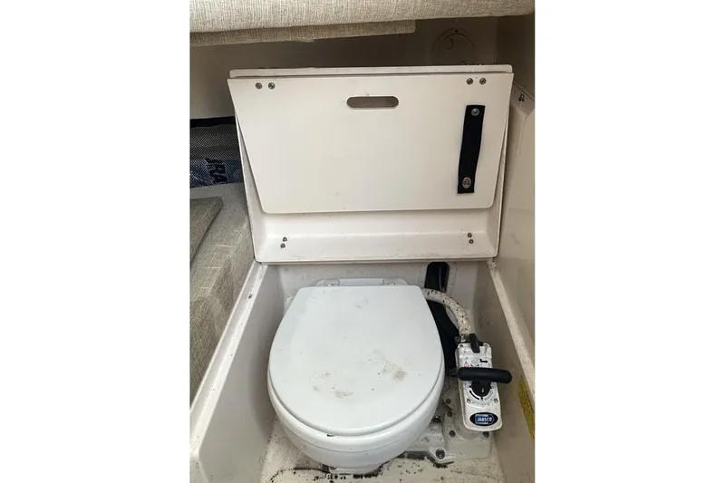 Slide: The Image of 2021 Grady-White Gulfstream 232 boat interior with compact marine toilet. - 47