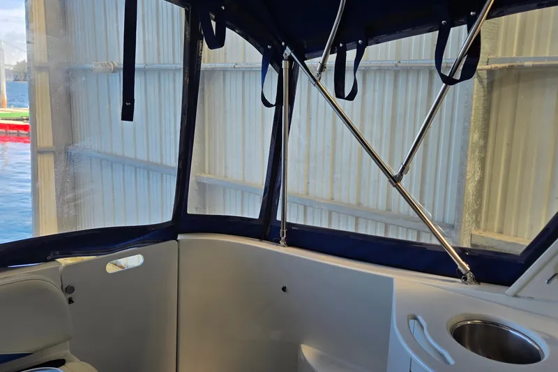 Slide: The Image of Interior view of a 2007 Bayliner 325 boat with blue canopy and seating. - 10