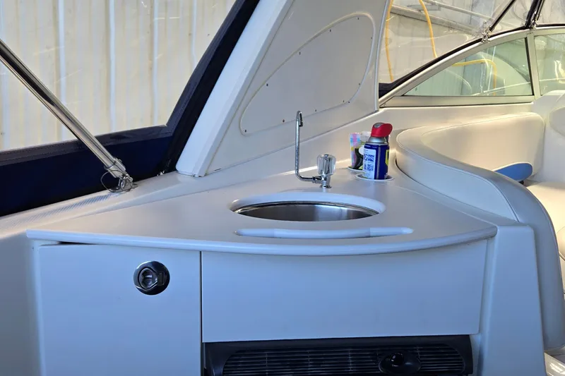 Slide: The Image of Interior of 2007 Bayliner 325 boat featuring a compact sink and seating area. - 11
