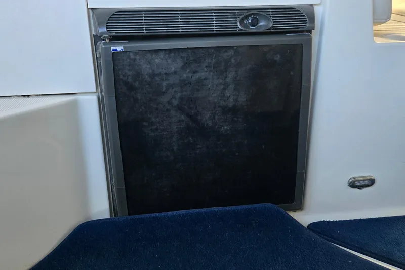 Slide: The Image of Compact refrigerator in a 2007 Bayliner 325 boat interior. - 12