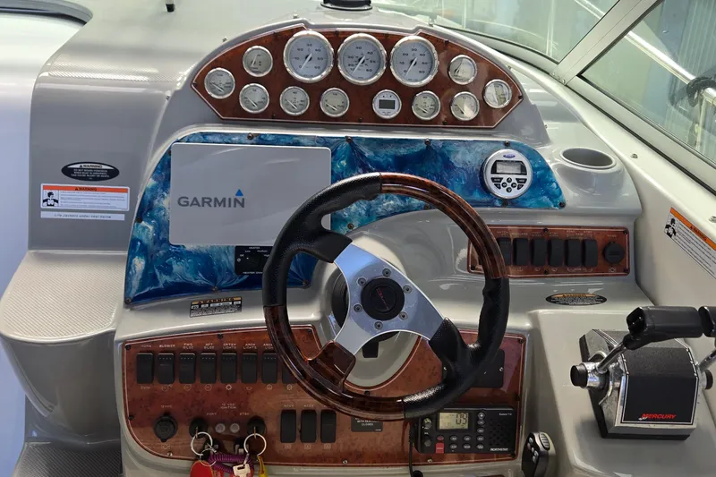 Slide: The Image of 2007 Bayliner 325 boat dashboard with Garmin navigation and Mercury controls. - 15