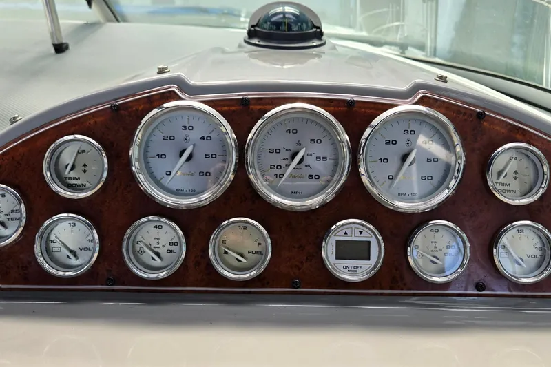 Slide: The Image of Dashboard of a 2007 Bayliner 325 boat with various gauges and controls. - 16