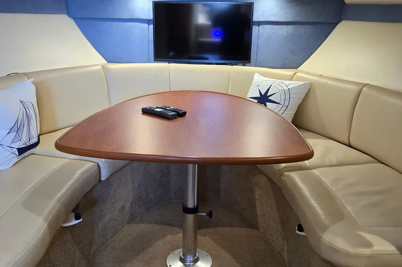 Slide: The Image of Luxurious interior of 2007 Bayliner 325 yacht with cozy seating and modern TV setup. - 21