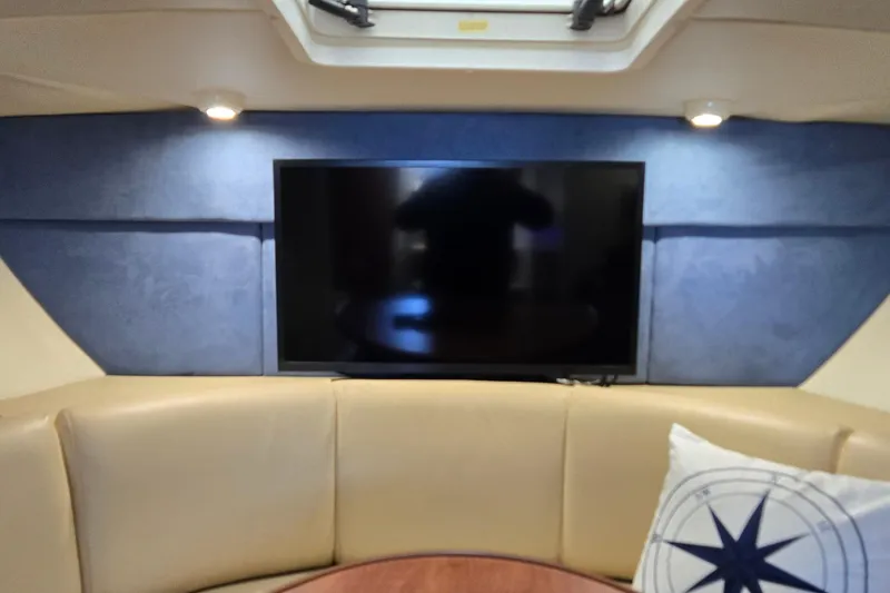 Slide: The Image of Interior of 2007 Bayliner 325 yacht with TV and beige seating area. - 25