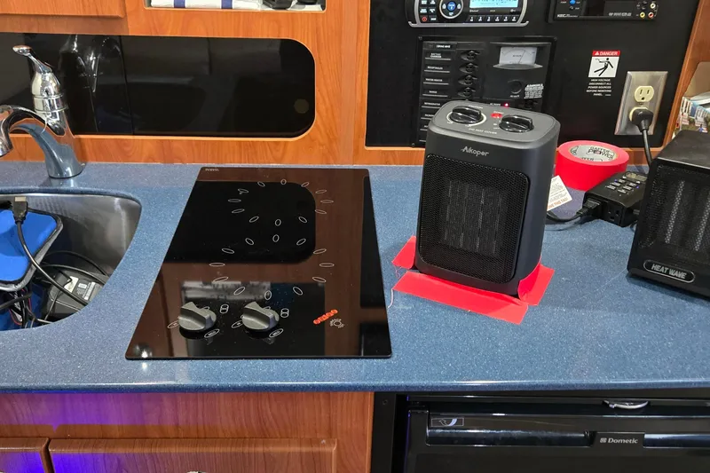 Slide: The Image of 2007 Bayliner 325 yacht kitchen with stove, heater, and sink. - 30