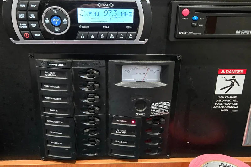 Slide: The Image of Control panel of a 2007 Bayliner 325 boat with radio and voltage meter. - 32