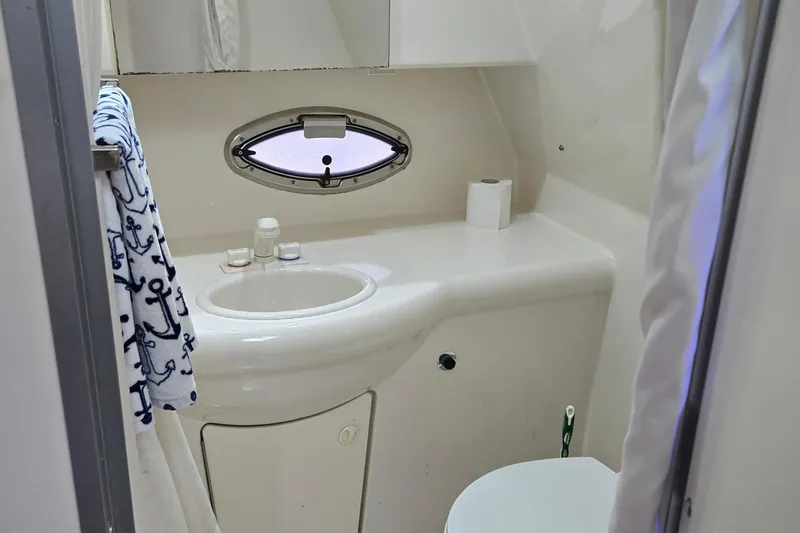 Slide: The Image of Bathroom interior of 2007 Bayliner 325 boat with sink, porthole, and nautical towel. - 36