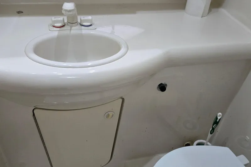 Slide: The Image of 2007 Bayliner 325 boat bathroom sink with faucet and storage compartment. - 37