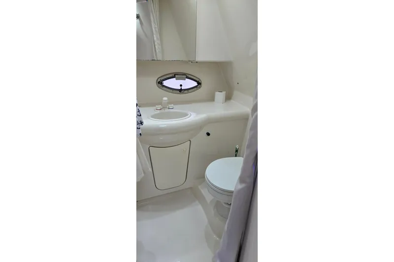 Slide: The Image of Bathroom interior of 2007 Bayliner 325 boat, featuring sink and toilet. - 39