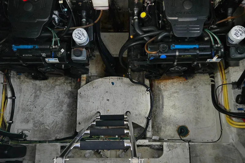 Slide: The Image of Engine compartment of a 2007 Bayliner 325 boat, featuring dual engines and maintenance ladder. - 40